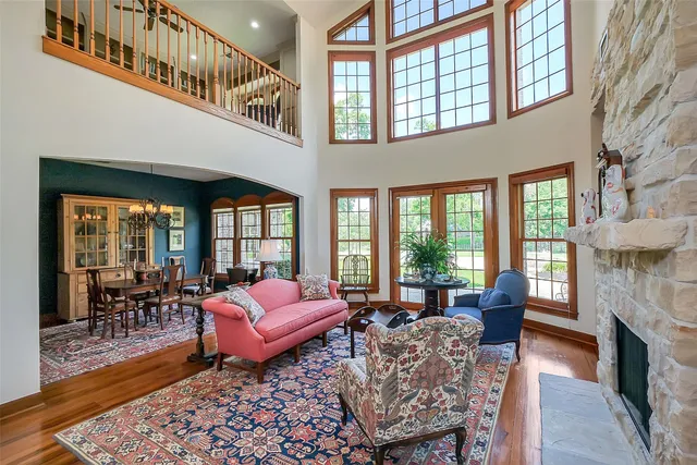a living room with furniture fireplace and windows