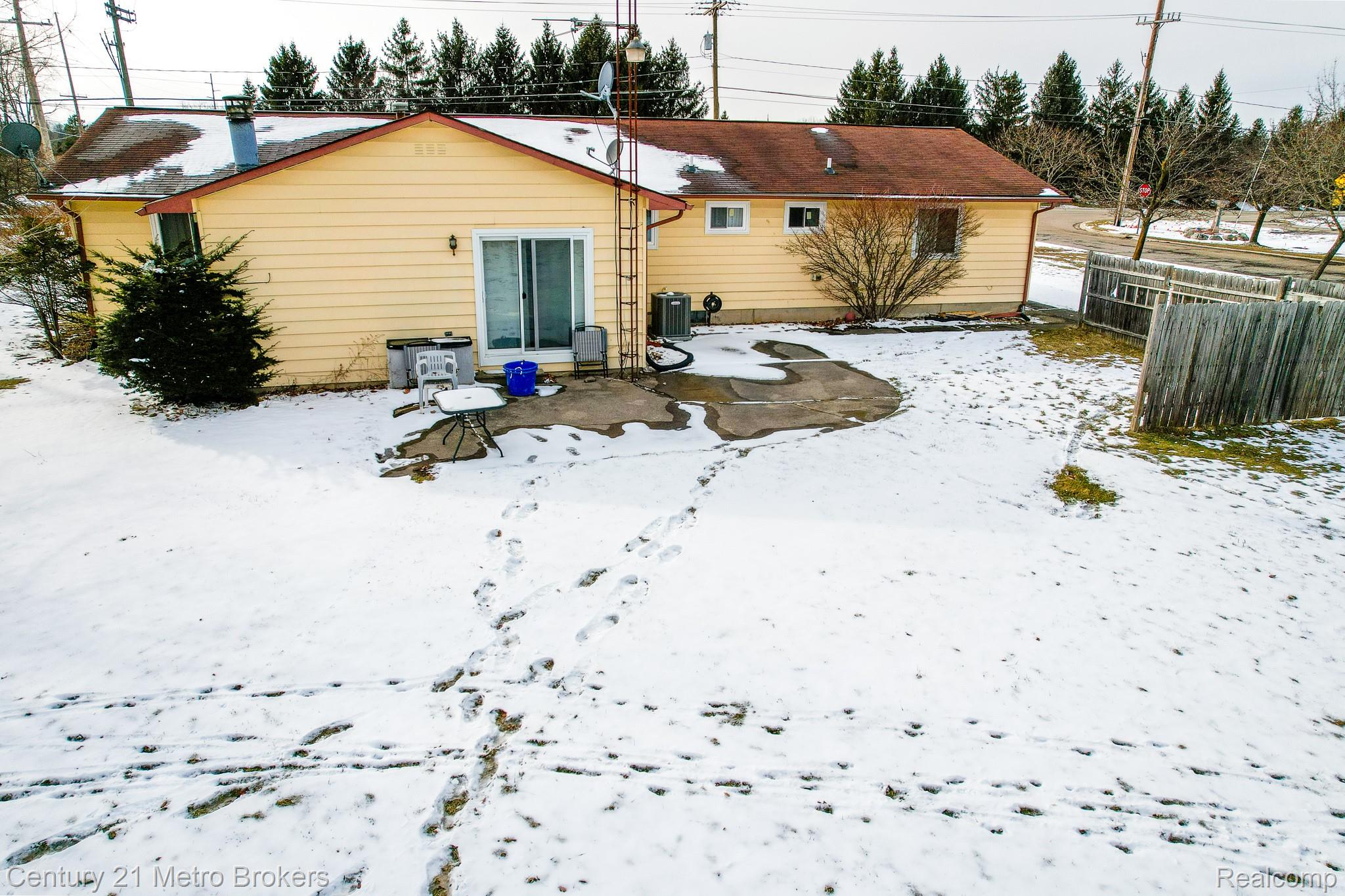 6101 Belsay Road Grand Blanc, MI 48439 - Photo 25 of 28 Snow covered back of property featuring a patio