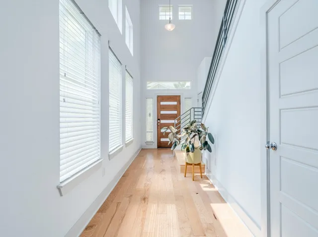 a view of entryway and hall with wooden floor