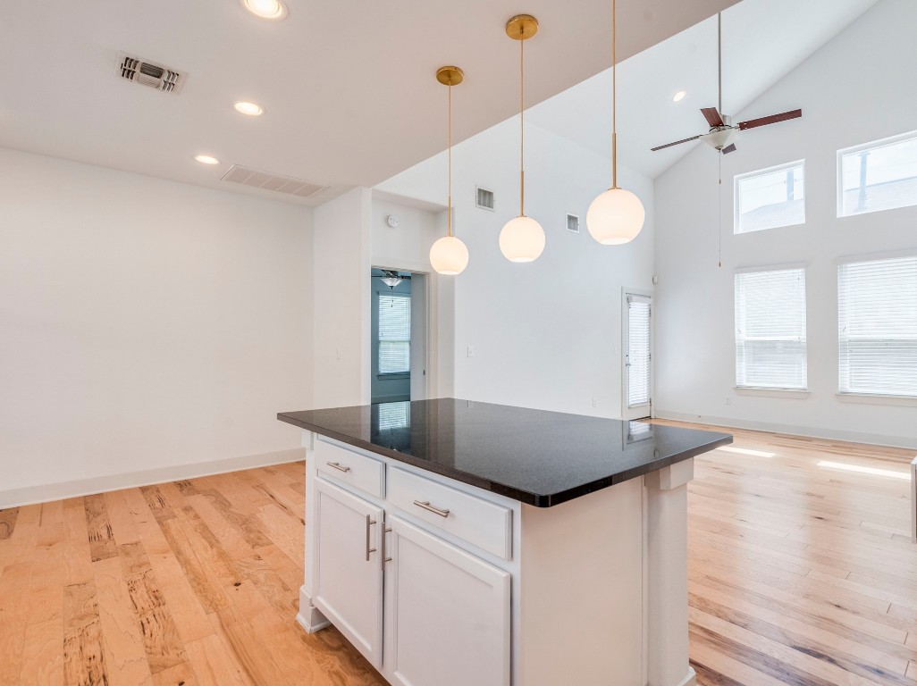 2309 Hermia Street Austin, TX 78741 - Photo 13 of 30 a kitchen with granite countertop a sink cabinets and wooden floor