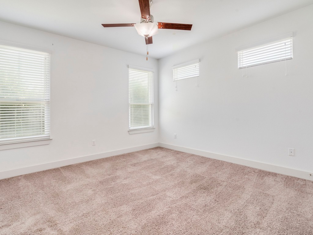 2309 Hermia Street Austin, TX 78741 - Photo 15 of 30 an empty room with windows and fan