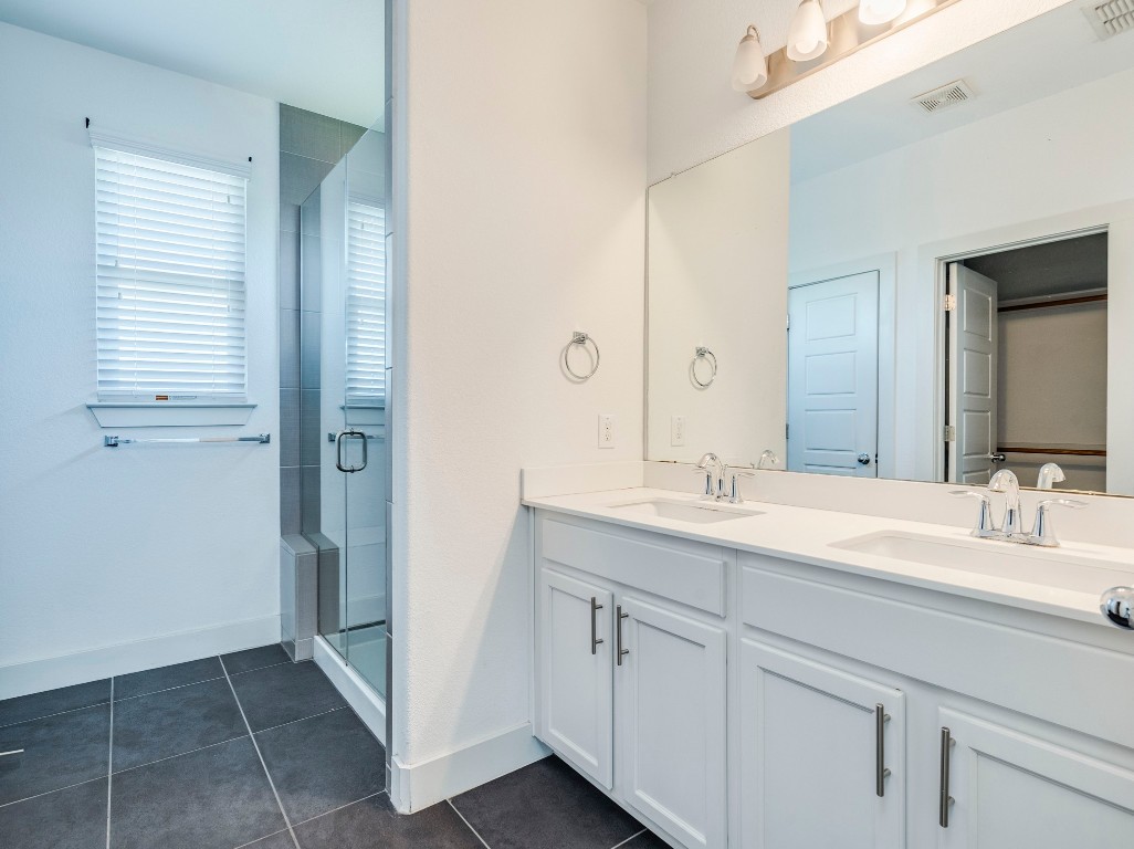 2309 Hermia Street Austin, TX 78741 - Photo 17 of 30 a bathroom with a double vanity sink and a mirror
