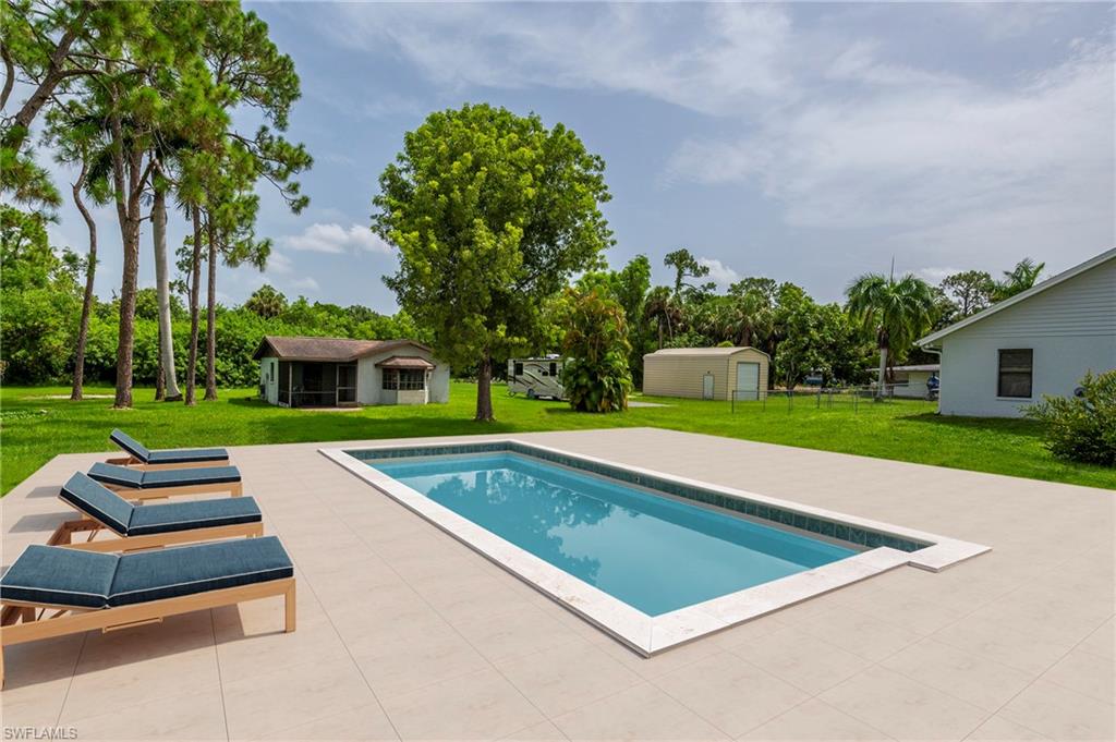 a view of swimming pool with a yard