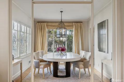 a dining room with furniture window and outside view