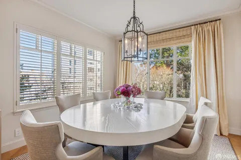 a dining room with furniture and window