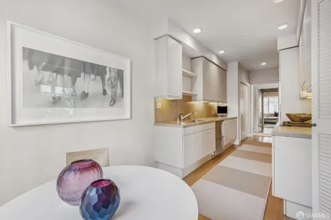 a kitchen with a sink cabinets and window