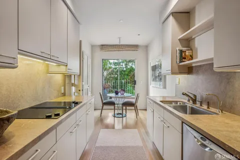a kitchen that has a sink and a stove