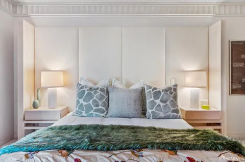 a bedroom with a bed and a lamp