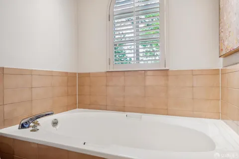 a bathroom with double vanity sinks and a mirror