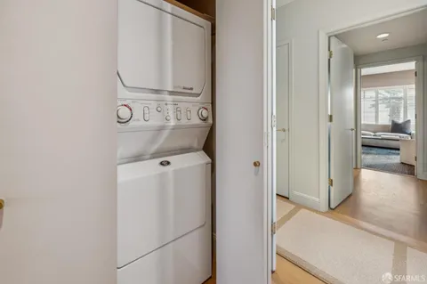 a view of a hallway with windows and natural light
