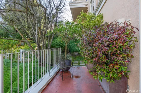 a garden with plants and outdoor seating