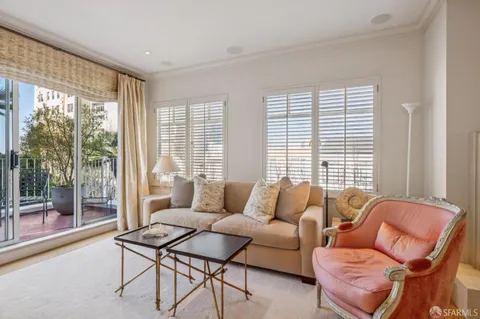 a living room with furniture and a floor to ceiling window