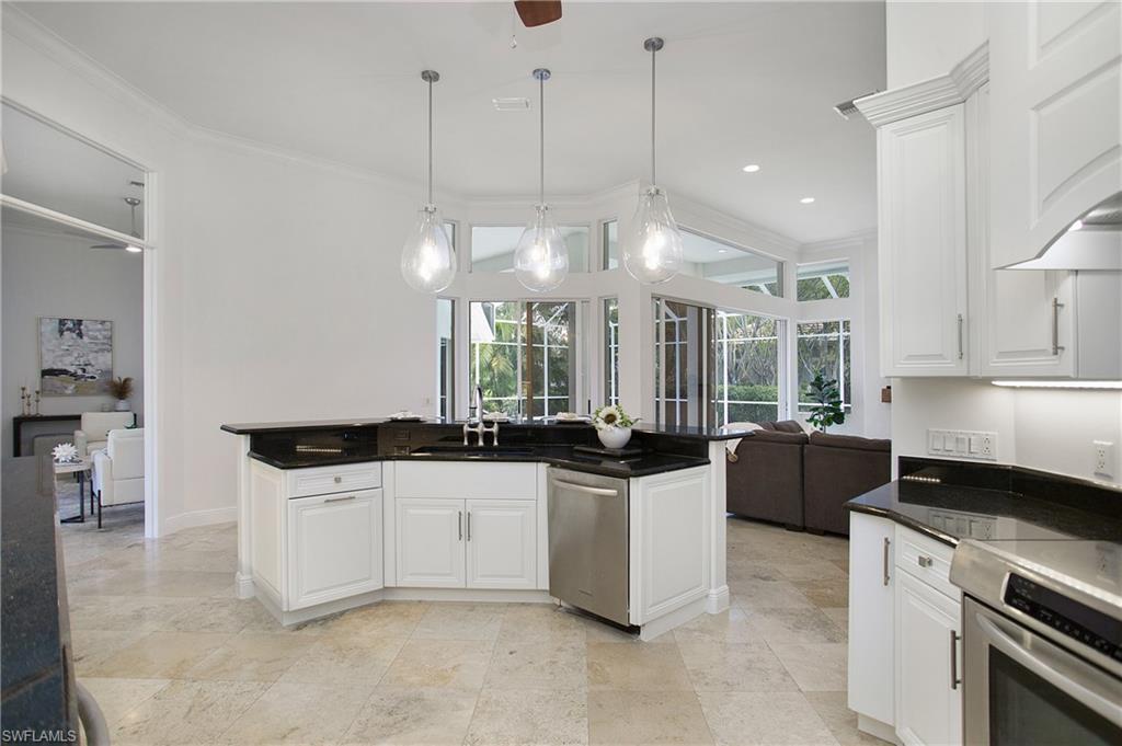 1984 Mission Drive Naples, FL 34109 - Photo 11 of 50 a kitchen with granite countertop a sink a counter top space appliances and cabinets