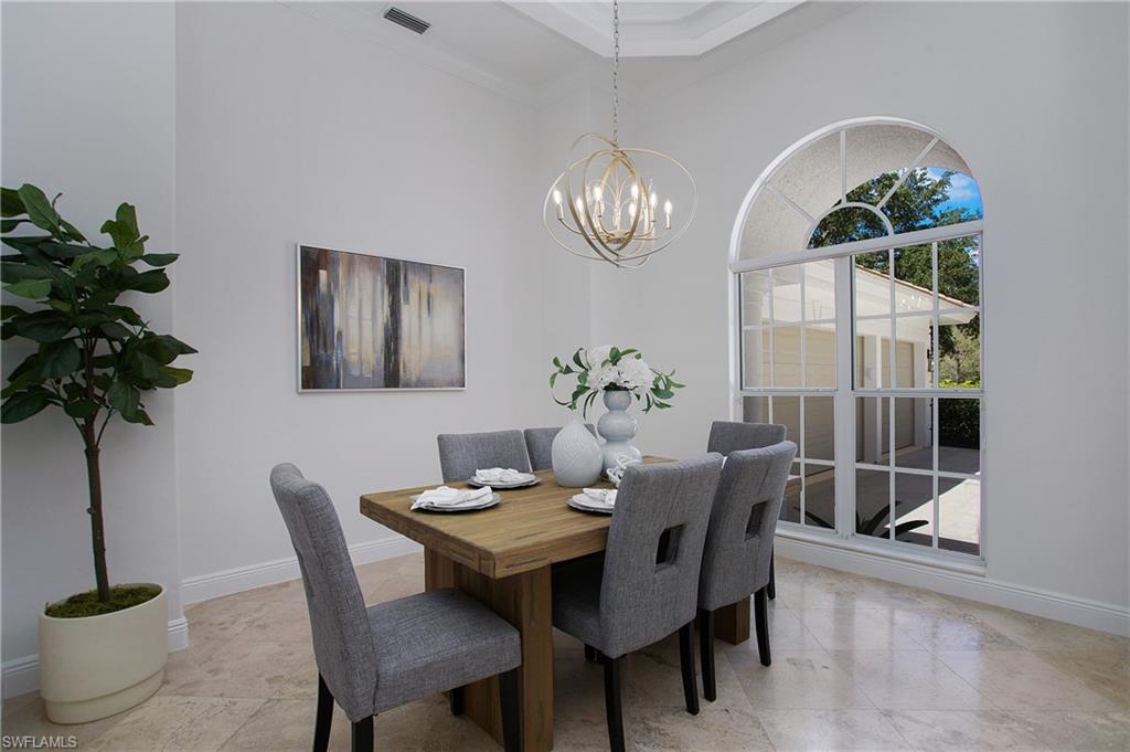 1984 Mission Drive Naples, FL 34109 - Photo 18 of 50 a view of a dining room with furniture wooden floor and chandelier