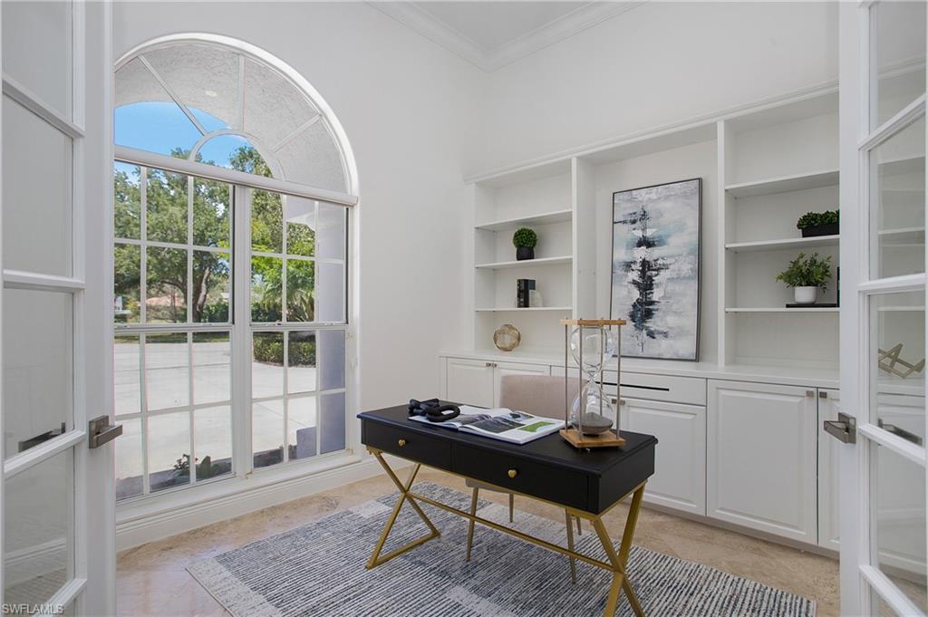 1984 Mission Drive Naples, FL 34109 - Photo 20 of 50 a living room with a table and a potted plant