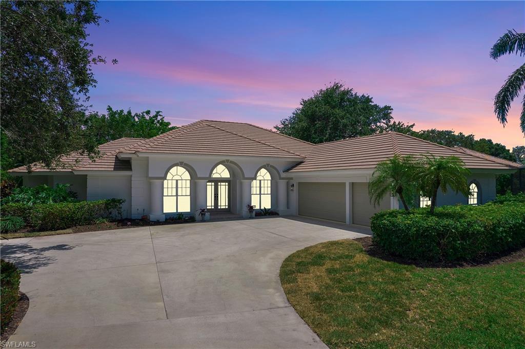 1984 Mission Drive Naples, FL 34109 - Photo 44 of 50 a front view of a house with a yard and garage