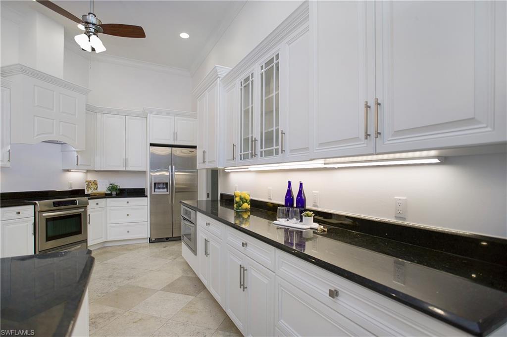 1984 Mission Drive Naples, FL 34109 - Photo 8 of 50 a kitchen with granite countertop cabinets stainless steel appliances and a sink