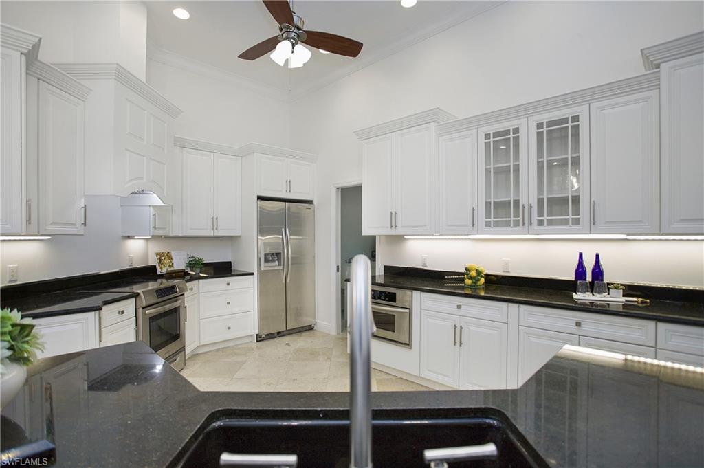 1984 Mission Drive Naples, FL 34109 - Photo 10 of 50 a kitchen with granite countertop a sink stainless steel appliances and cabinets