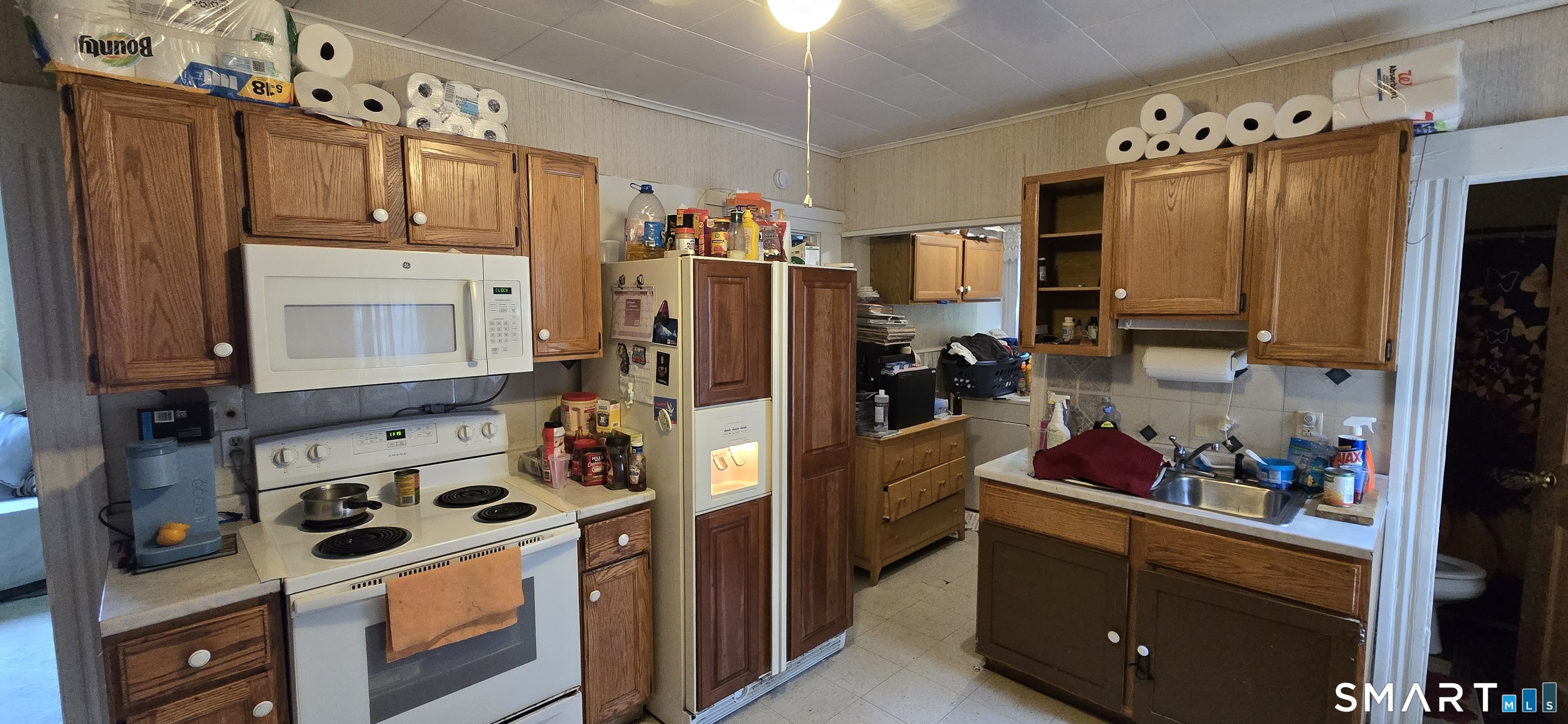 25 High Street Torrington, CT 06790 - Photo 11 of 16 a kitchen with stainless steel appliances a stove a refrigerator and cabinets