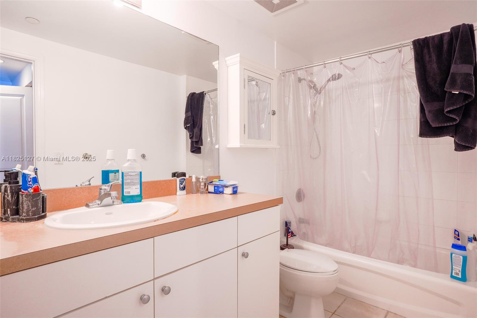 1250 South Miami Avenue, Unit 3003 Miami, FL 33130 - Photo 17 of 31 a bathroom with a sink a toilet and shower curtain