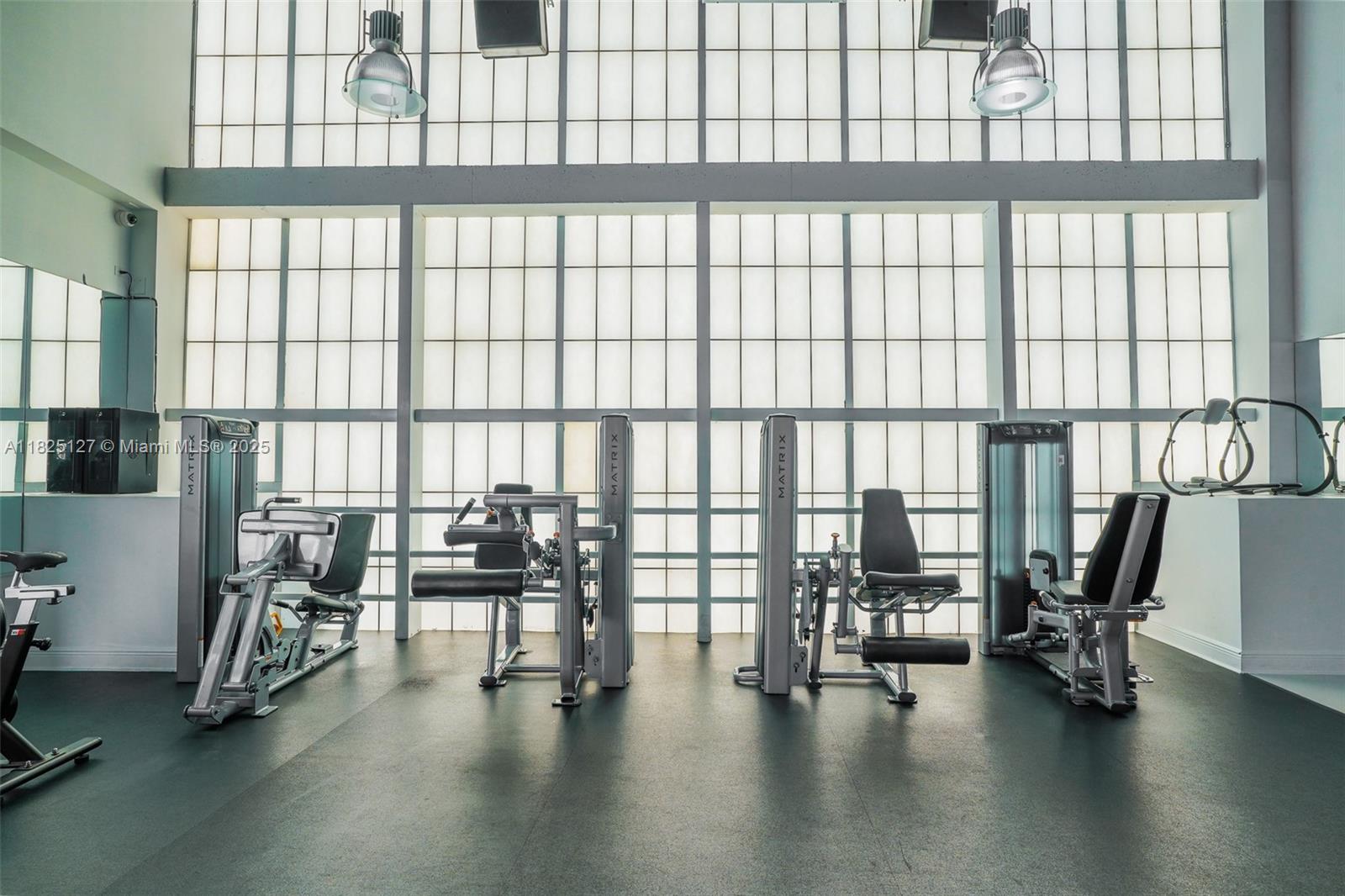 1250 South Miami Avenue, Unit 3003 Miami, FL 33130 - Photo 28 of 31 a view of a workspace with furniture and floor to ceiling window