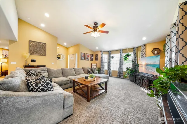 a living room with furniture flowerpot and a chandelier