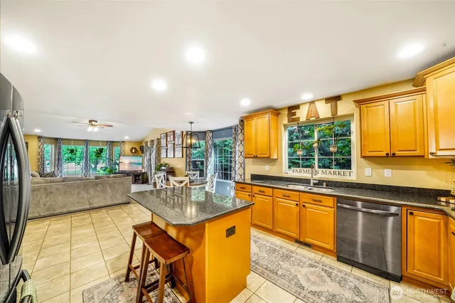 a kitchen with stainless steel appliances granite countertop sink stove and cabinets