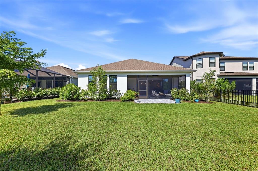 9268 Tequila Sunrise Drive Sarasota, FL 34241 - Photo 34 of 56 a front view of a house with a yard