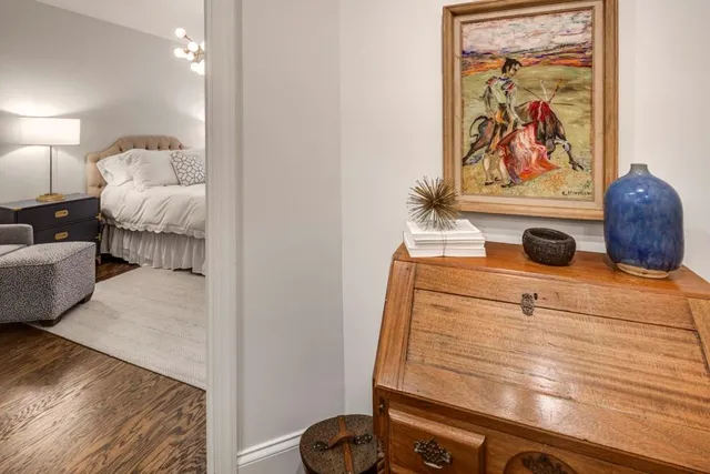 a bedroom with a bed and wall painting