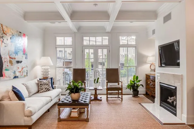 a living room with furniture fireplace and a flat screen tv