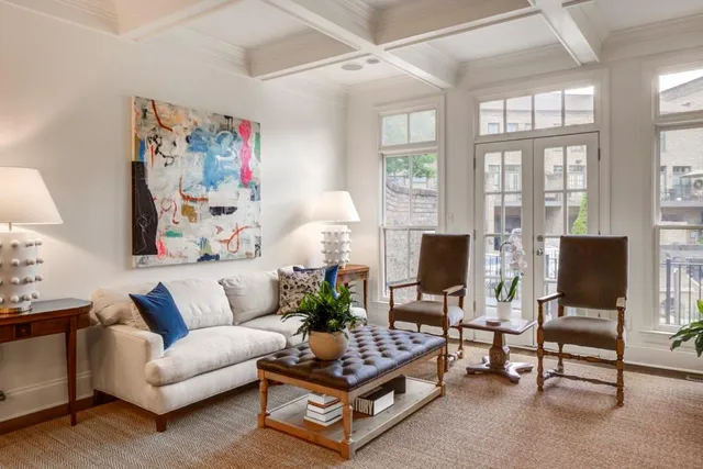 a living room with furniture a flat screen tv and a window