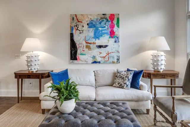 a living room with furniture and flowers