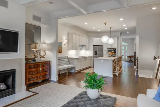 a kitchen with a table chairs refrigerator and a fireplace