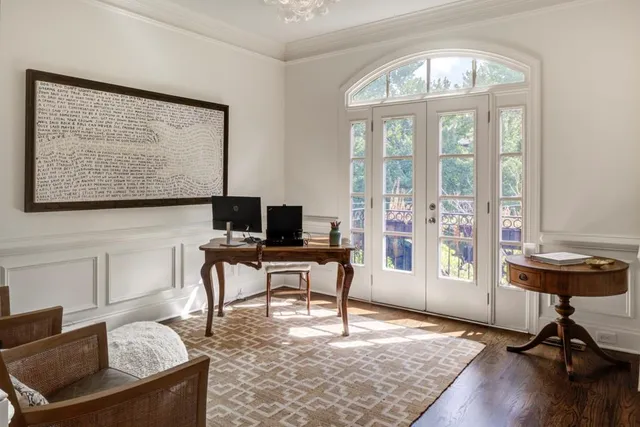 a view of a livingroom with workspace and a window