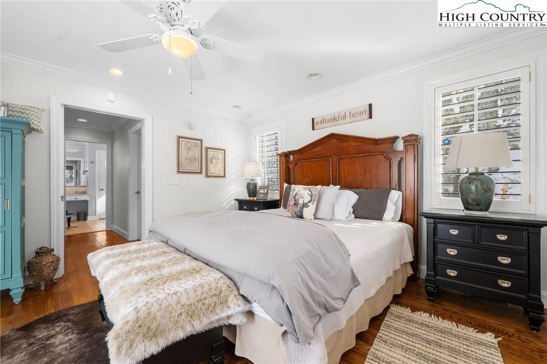 123 St Andrews Road Beech Mountain, NC 28604 - Photo 13 of 47 a bedroom with a bed and a chandelier