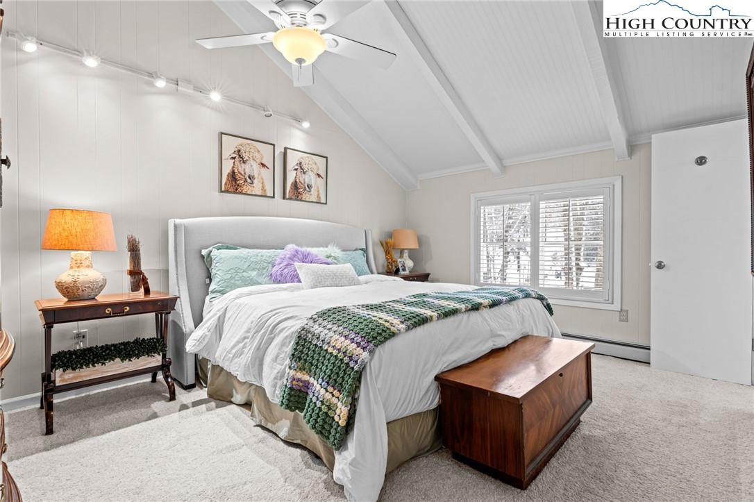 123 St Andrews Road Beech Mountain, NC 28604 - Photo 19 of 47 a spacious bedroom with a bed and a couch