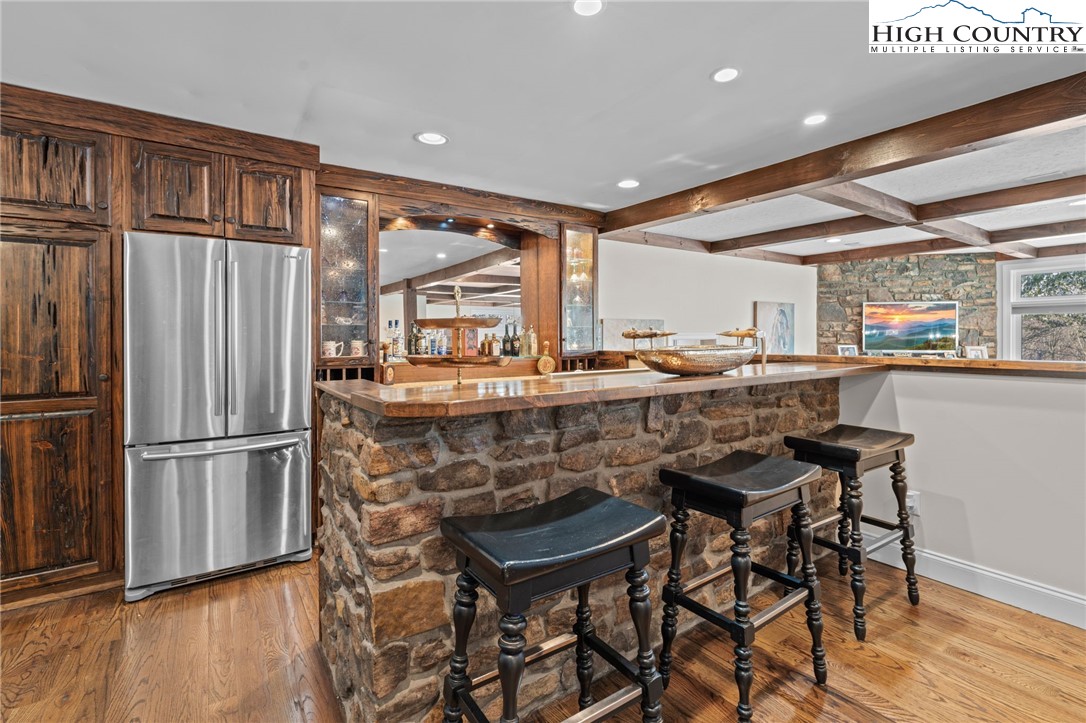 123 St Andrews Road Beech Mountain, NC 28604 - Photo 23 of 47 a kitchen with a table chairs refrigerator and wooden floor