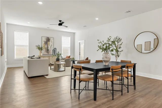 a view of a dining room with furniture and wooden floor