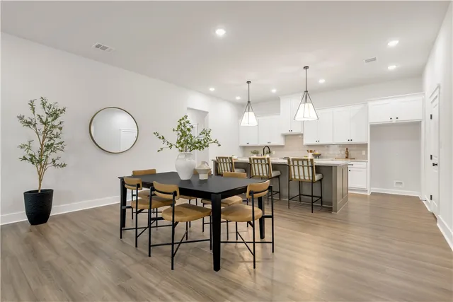 a living room with dining room and wooden floor