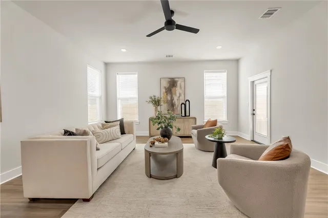 a kitchen with a dining table chairs stainless steel appliances and cabinets