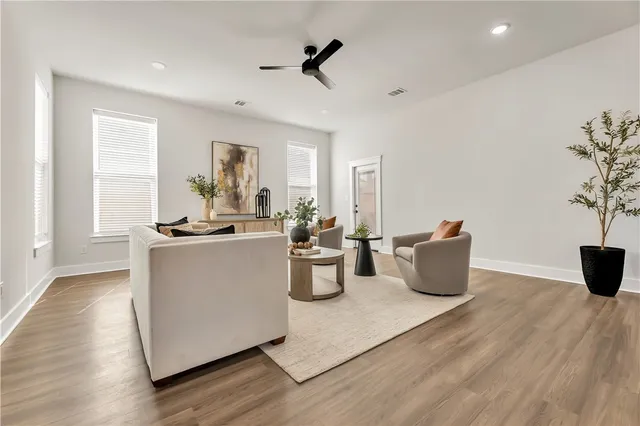 a living room with furniture potted plant and a window