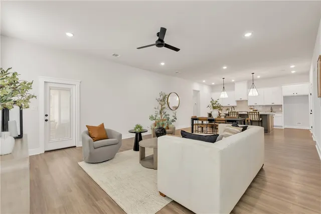 a living room with furniture and wooden floor