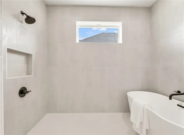 a bathroom with double vanity sinks and a mirror