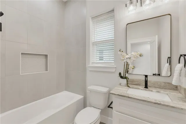 a white toilet sitting next to a bathroom sink