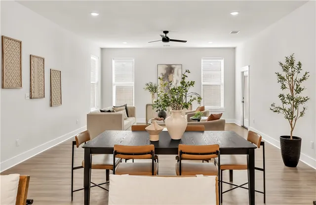 a kitchen with a stove a sink a kitchen island with wooden floor and cabinets