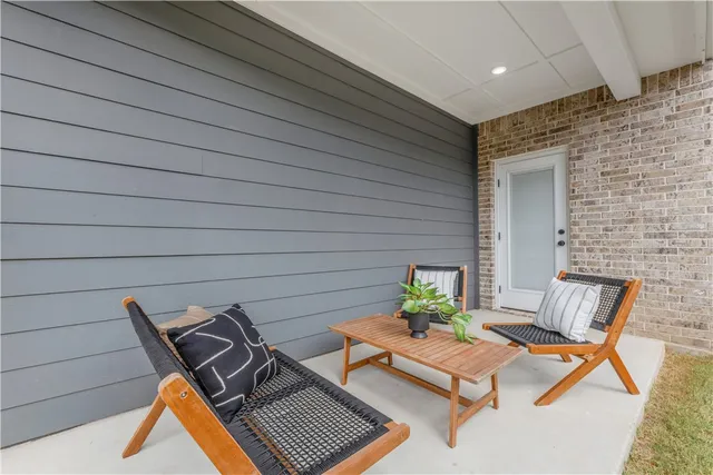 a view of a backyard with table and chairs and wooden fence