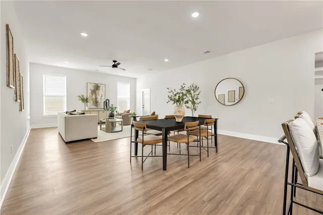 a kitchen with a stove and a wooden floor