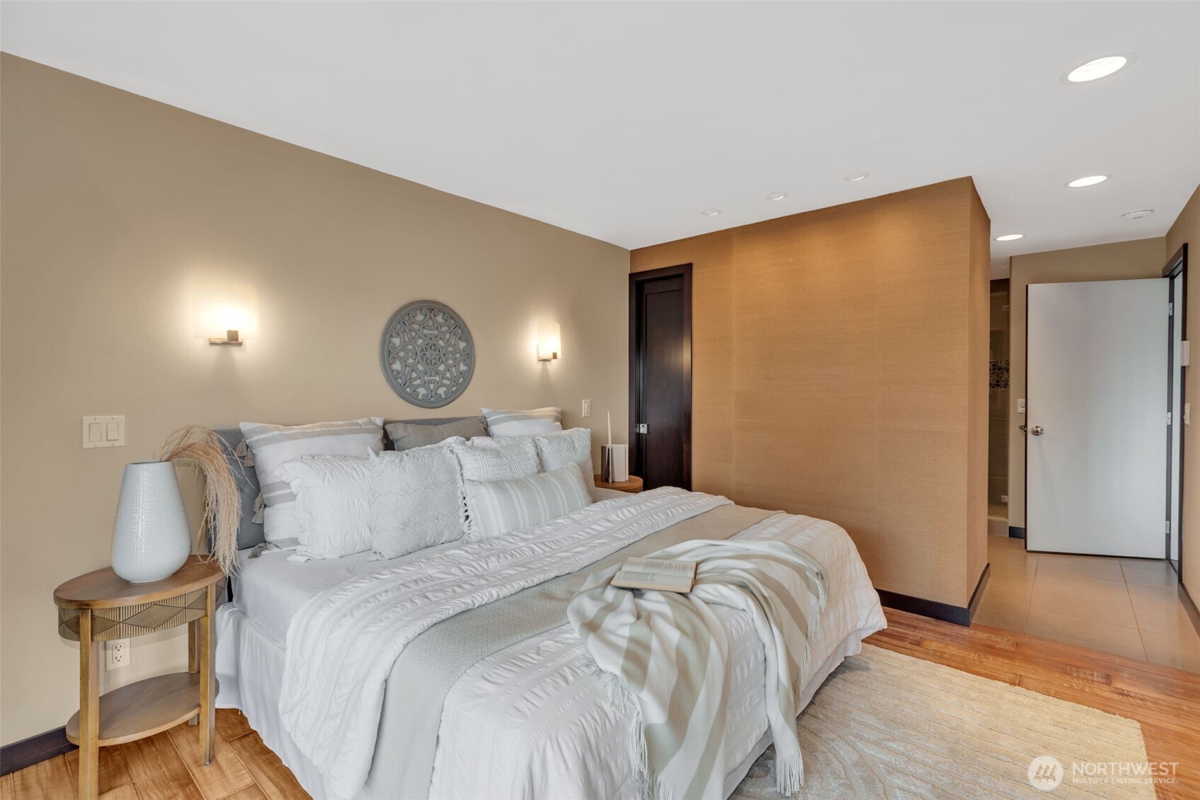 1231 5th Avenue North, Unit 101 Seattle, WA 98109 - Photo 12 of 31 a bedroom with a bed and a chair