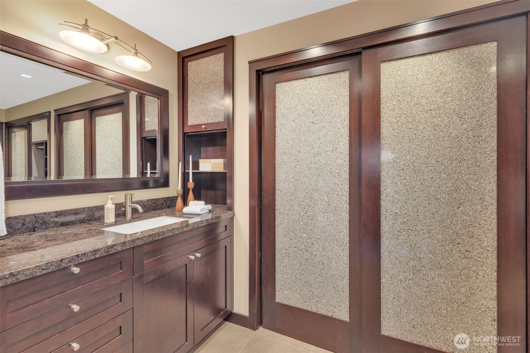 1231 5th Avenue North, Unit 101 Seattle, WA 98109 - Photo 14 of 31 a bathroom with a granite countertop sink and a mirror