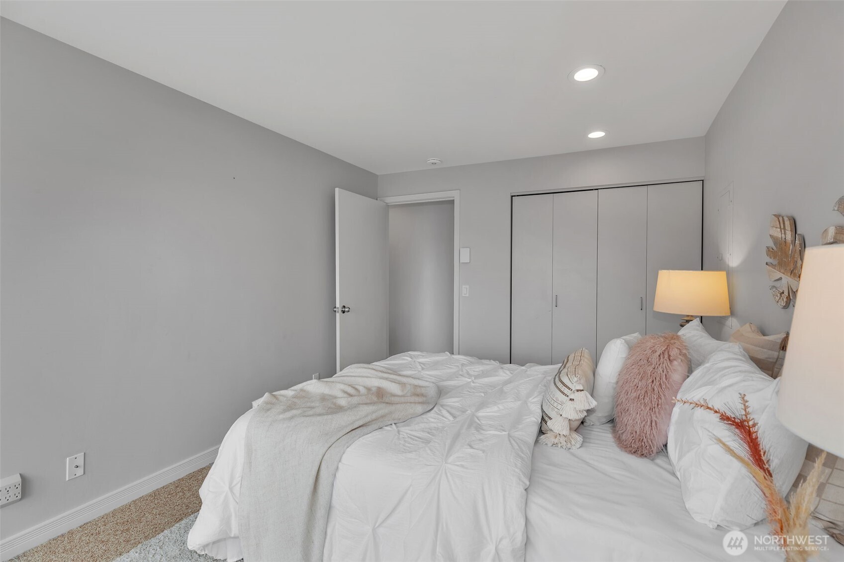 1231 5th Avenue North, Unit 101 Seattle, WA 98109 - Photo 17 of 31 a bedroom with a bed and a lamp